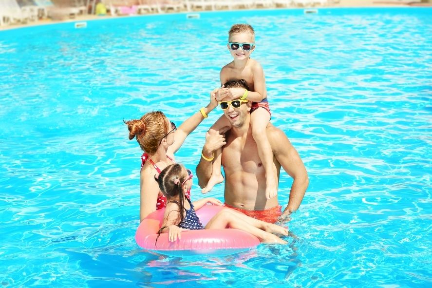 Happy Family Swimming in Pool in Katathani Phuket Beach Resort